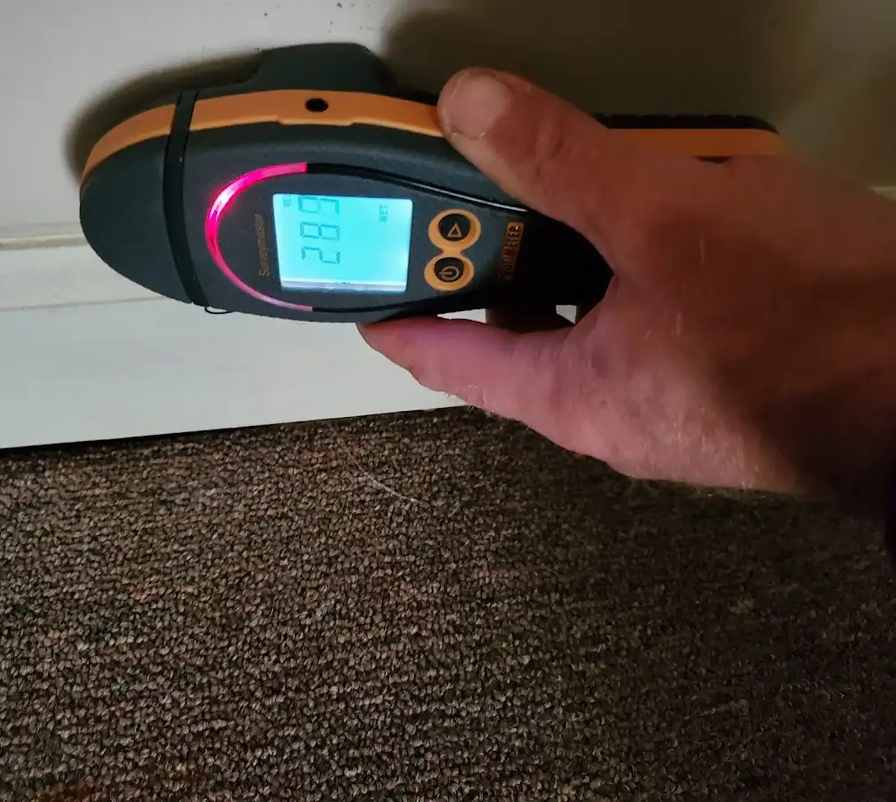 Moisture detection at baseboard during Storm Damage Restoration in North Aurora